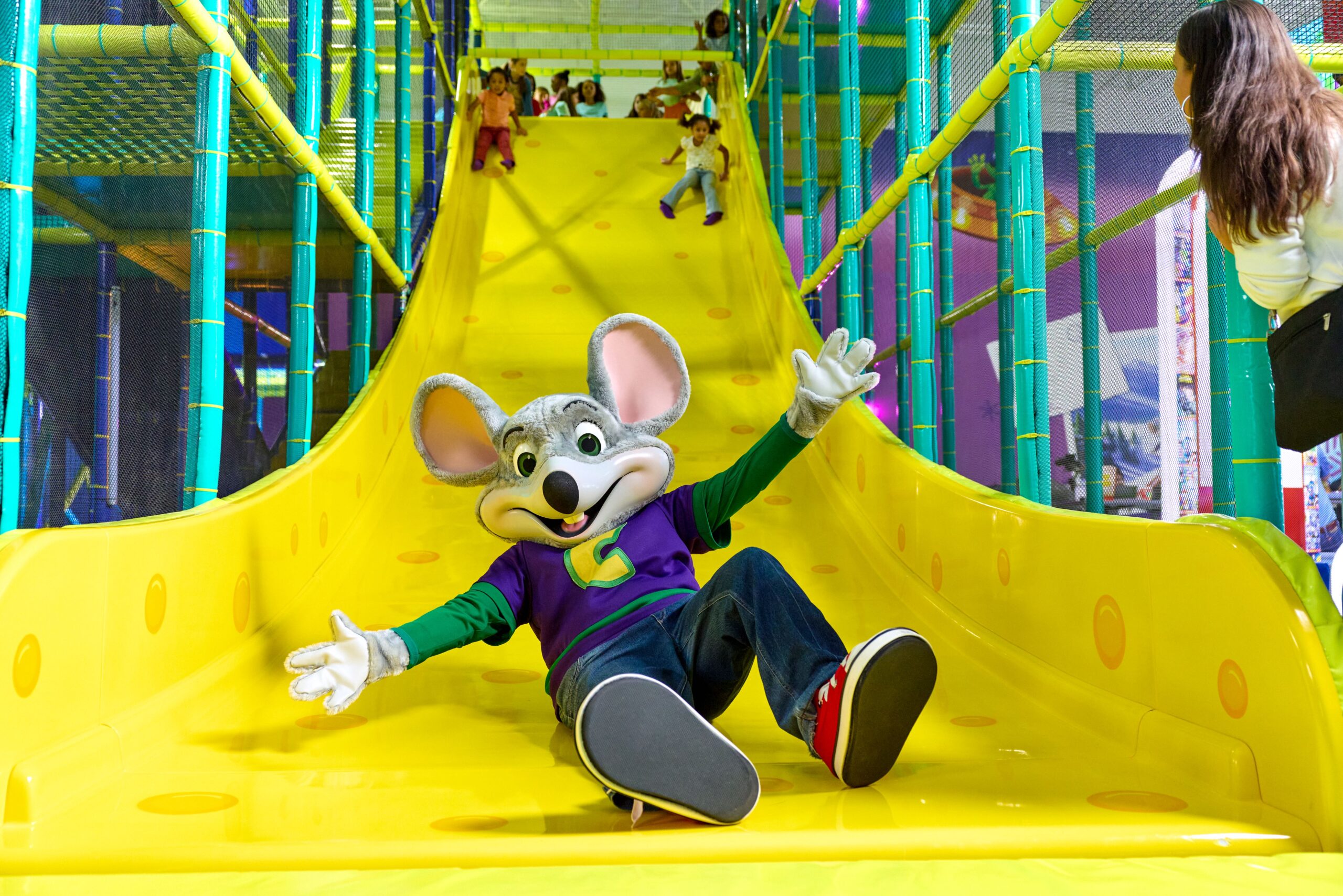 Chuck E. coming down the slide at Adventure World