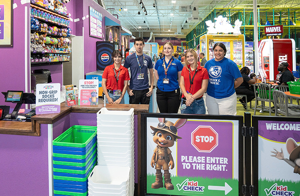 The Kid Check stand at the Adventure World entrance, staffed by team members ready to check guests in