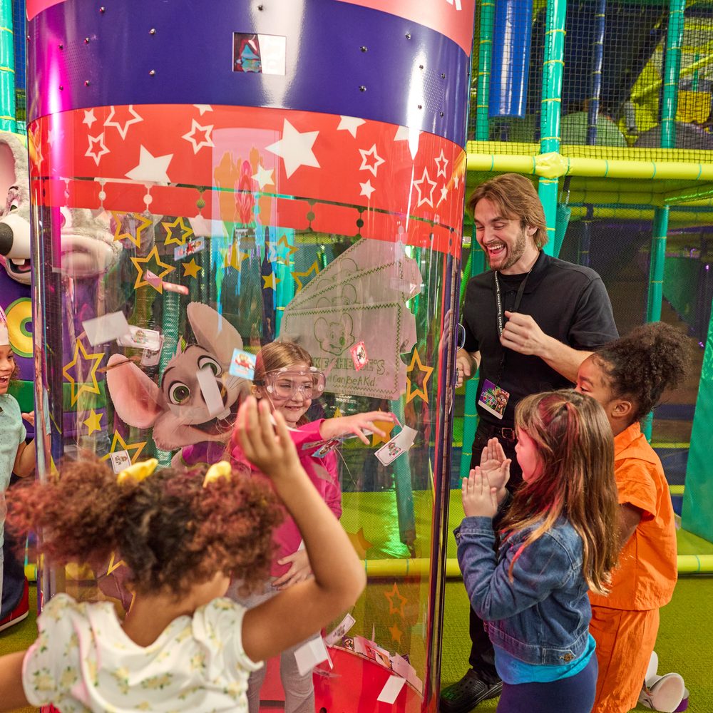 Kids grabbing flying tickets inside the Ticket Blaster at Adventure World